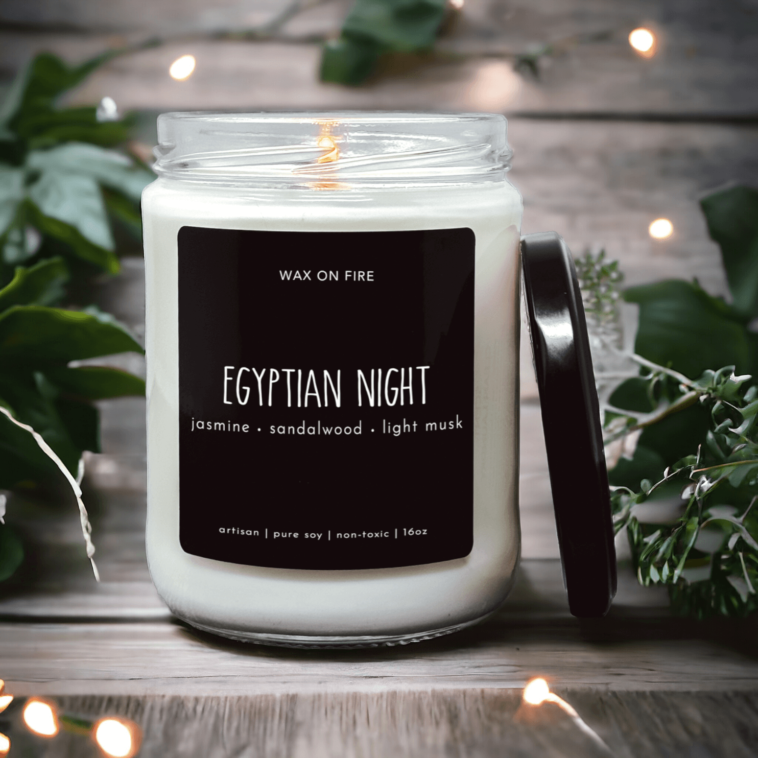 Egyptian Night candle in a jar with a black label; features jasmine, sandalwood, and light musk scents.