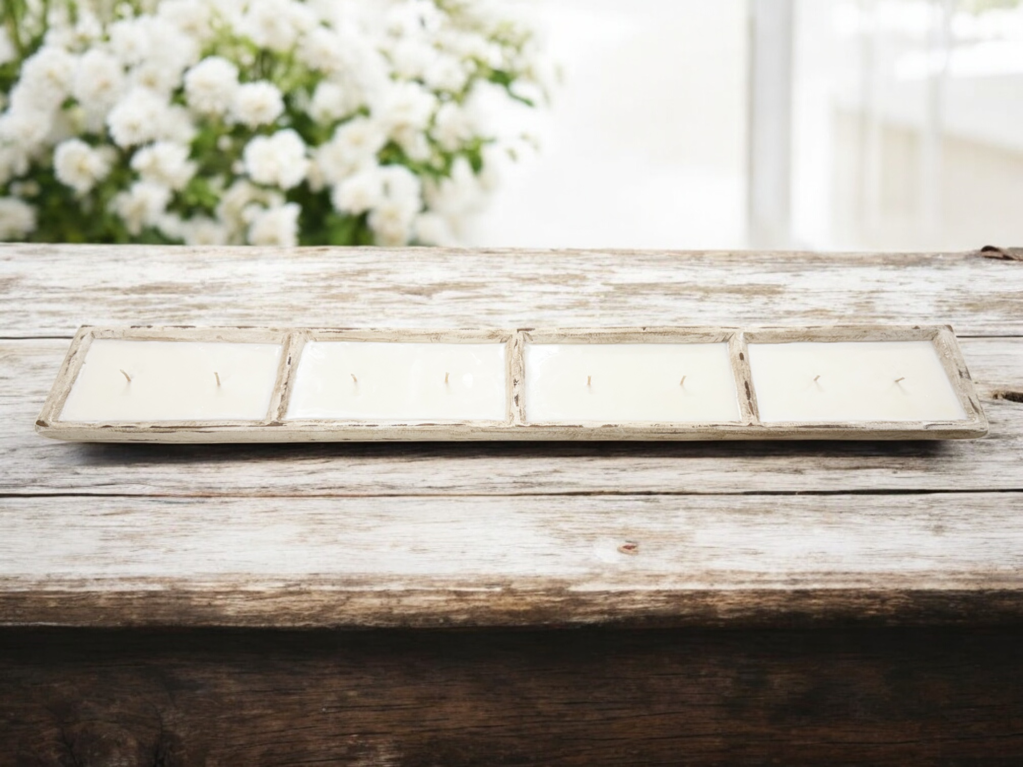 80oz hand-carved dough bowl candle on a rustic wooden table with fresh flowers in the background.