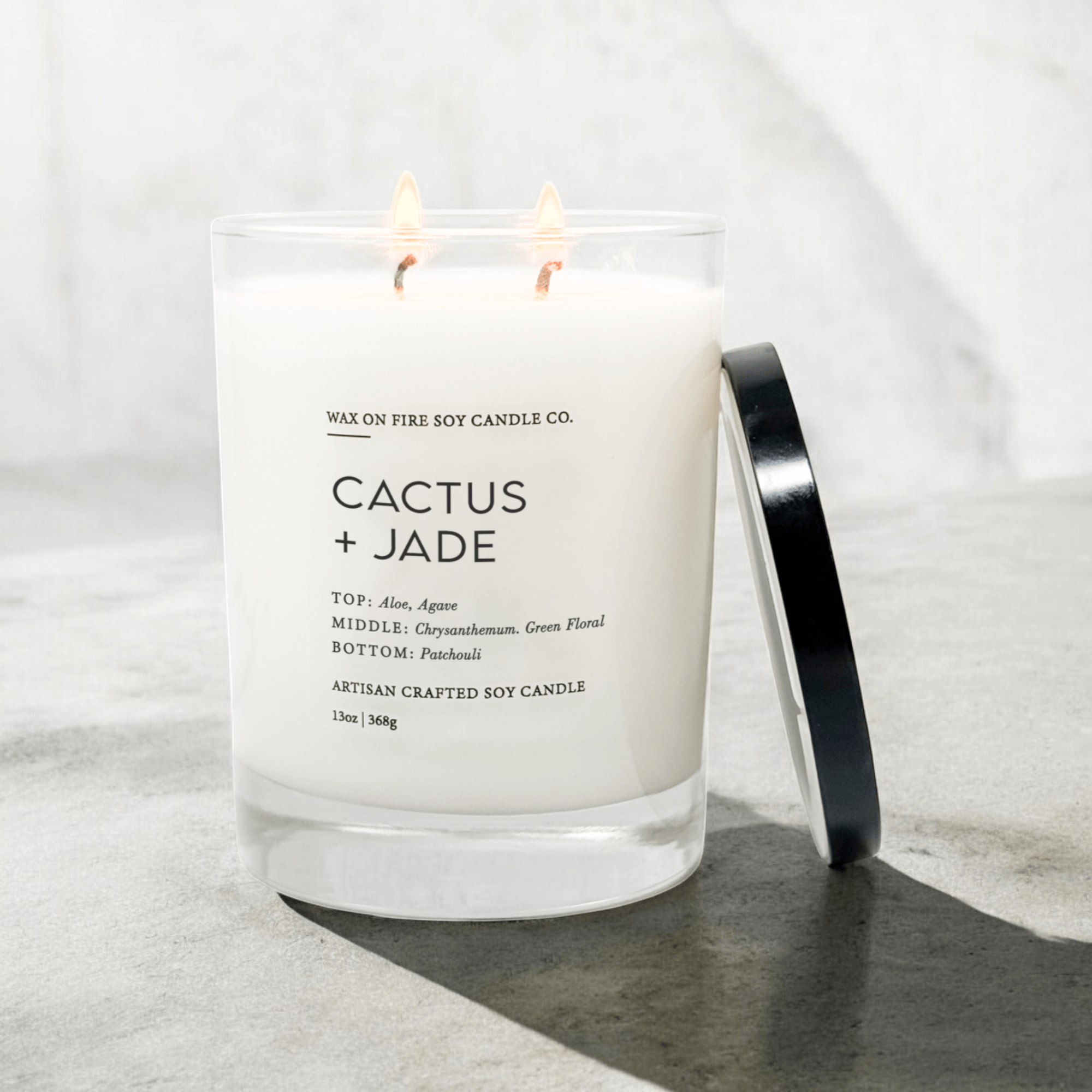 Cactus + Jade Signature Luxe 2-Wick Candle in clear glass jar with black lid and fresh floral scent notes.