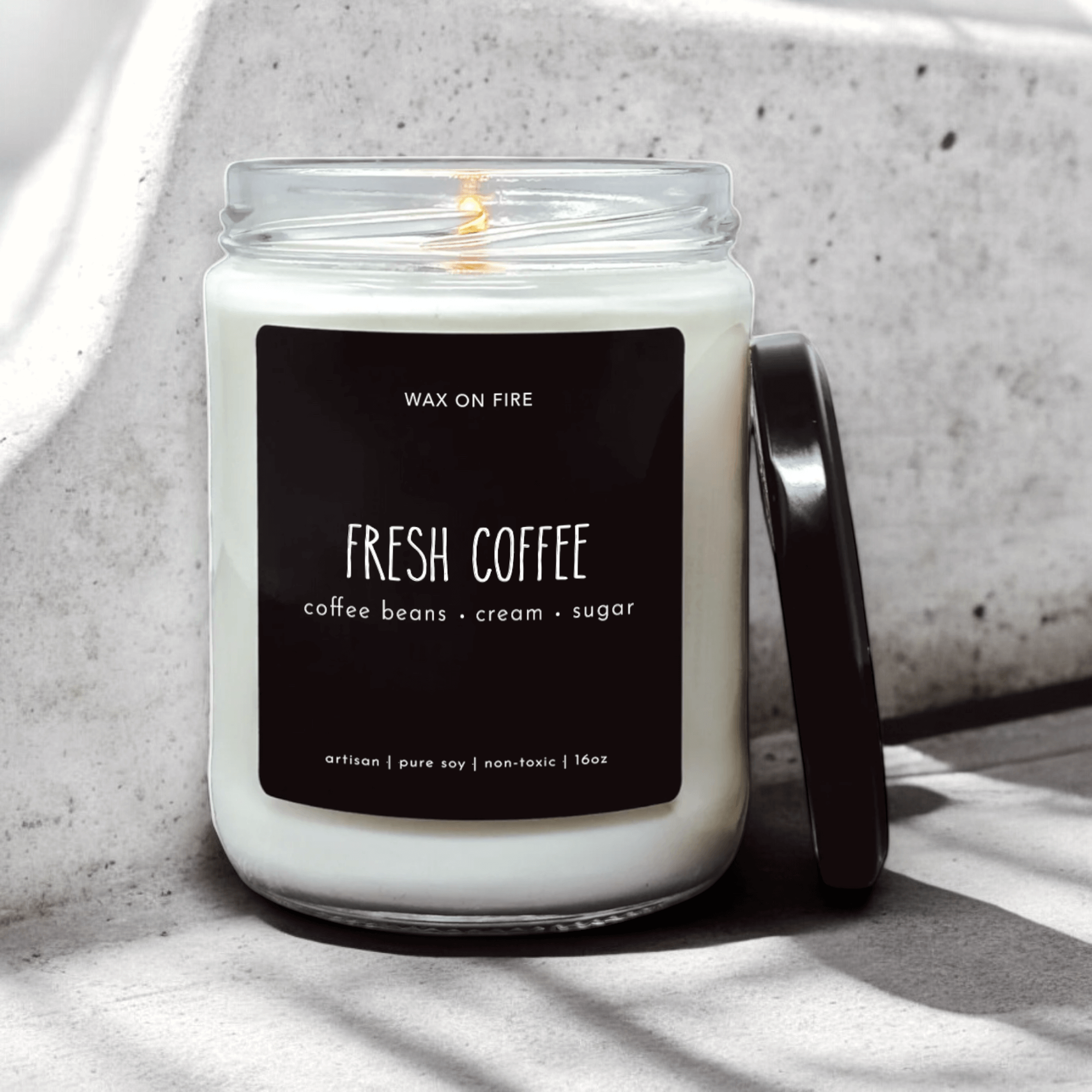 Fresh Coffee candle in a glass jar, featuring notes of coffee beans, cream, and sugar for a cozy atmosphere.