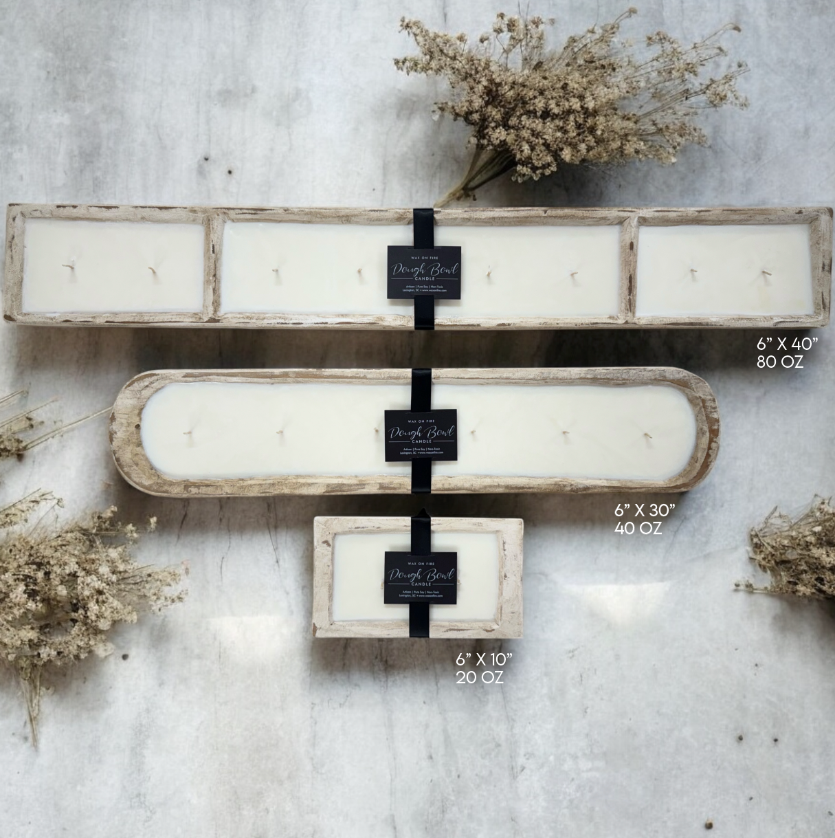 Three hand-carved dough bowl candles on a light surface, showcasing rustic design and warm ambiance.