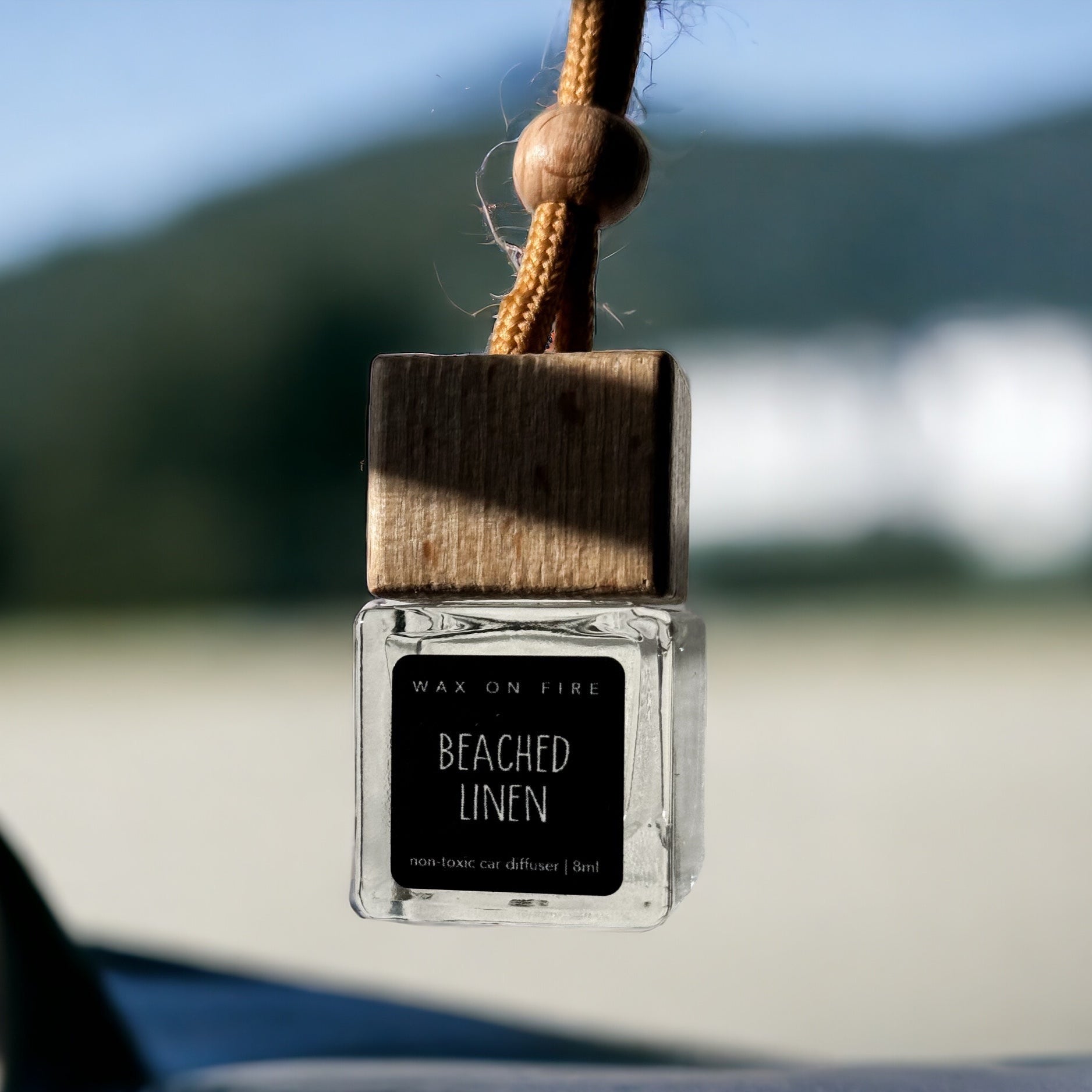 Handcrafted hanging car diffuser with Beached Linen scent, elegantly designed for a sophisticated car interior.
