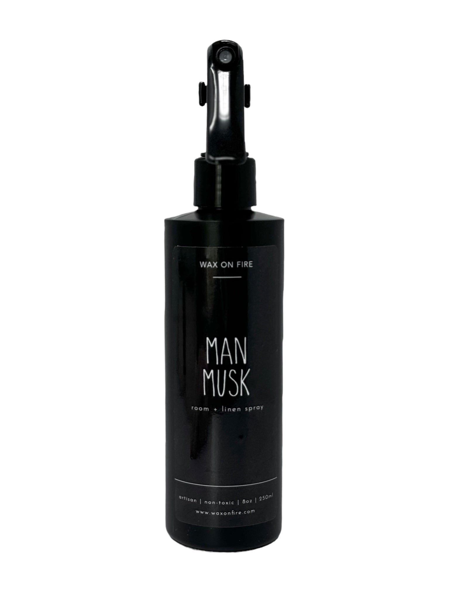 Room + linen spray in sleek black bottle, labeled 'Man Musk', eco-friendly and non-toxic for a fresh, luxurious environment.