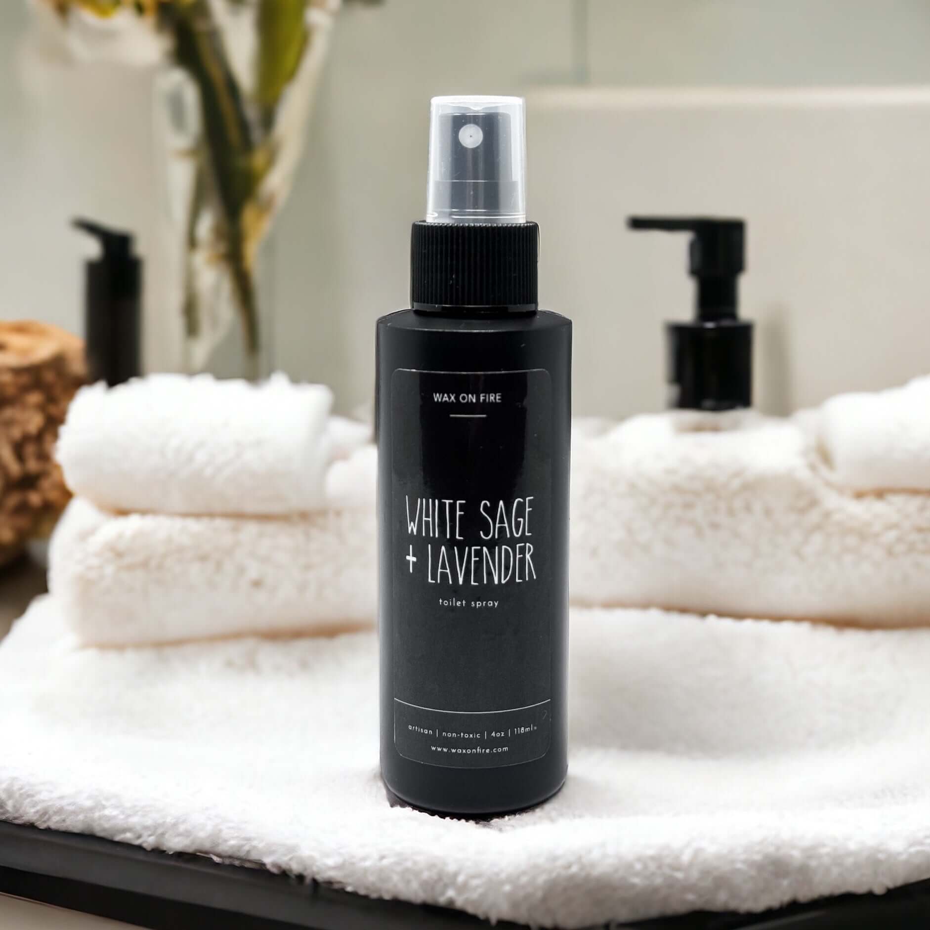 White Sage and Lavender room spray bottle on a soft towel, perfect for creating a calming atmosphere.