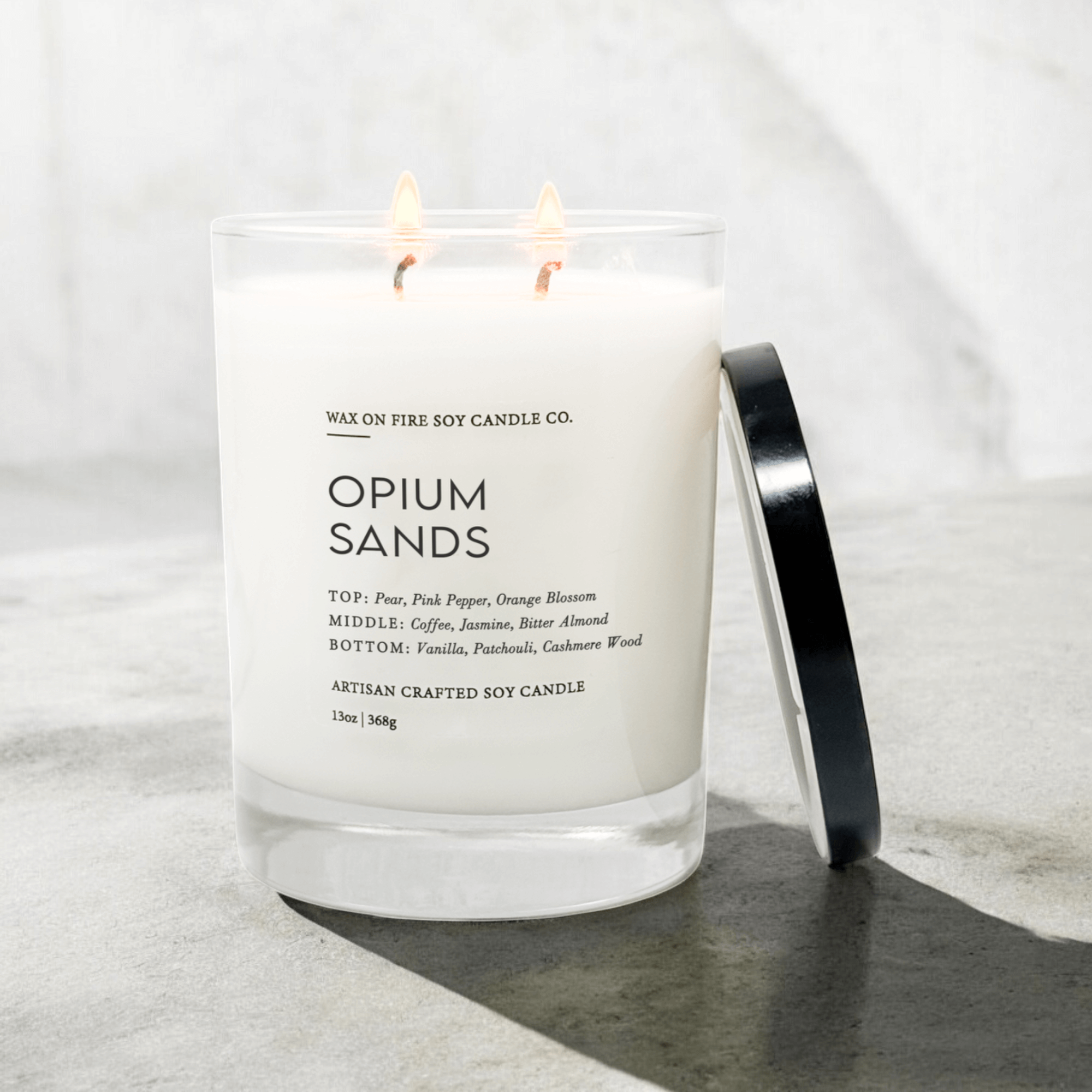 Opium Sands Signature Luxe 2-Wick Candle in glass jar with lid, featuring warm scents of pear, coffee, and vanilla.
