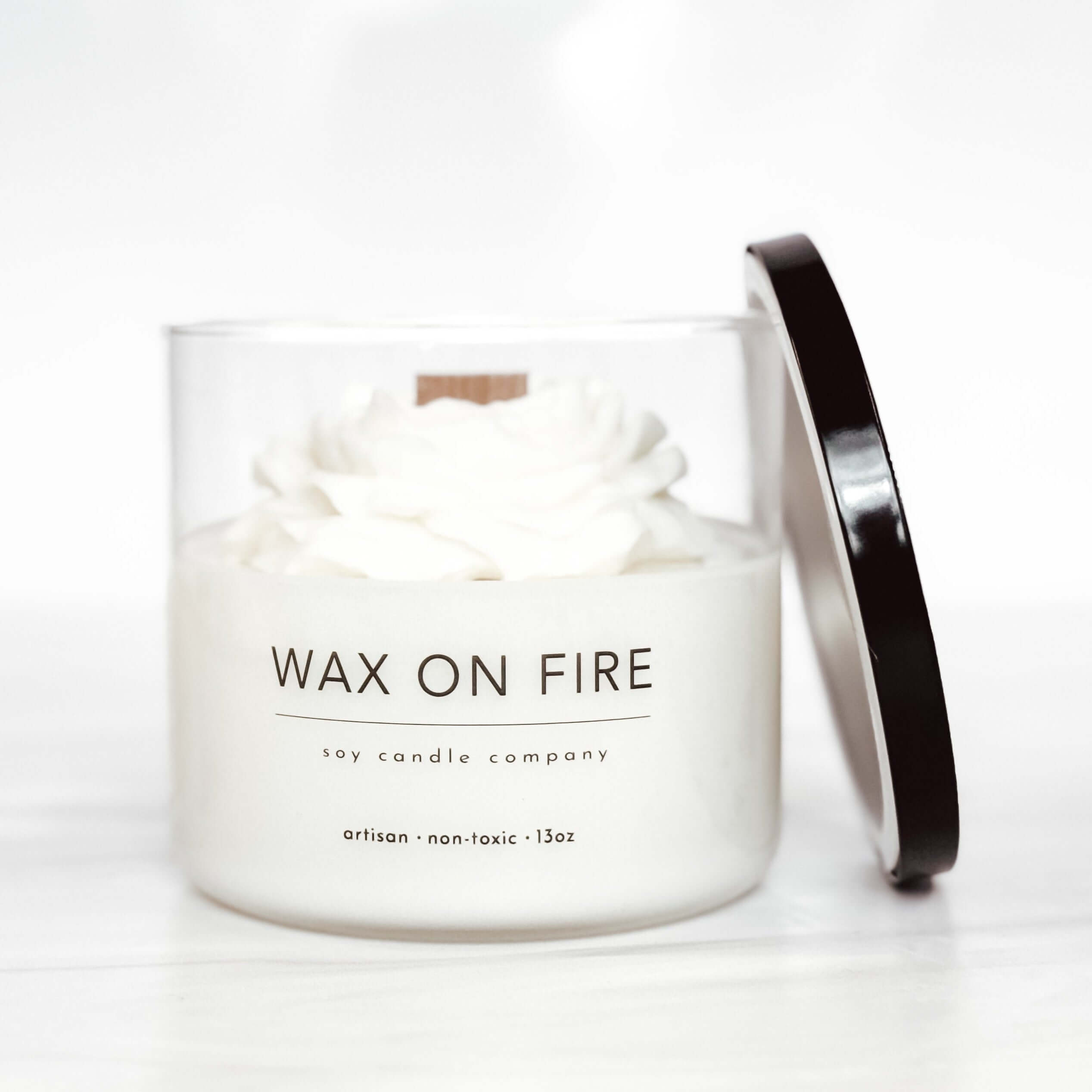 Peony flower candle in a glass jar with a wooden wick, showcasing artisan, non-toxic design.