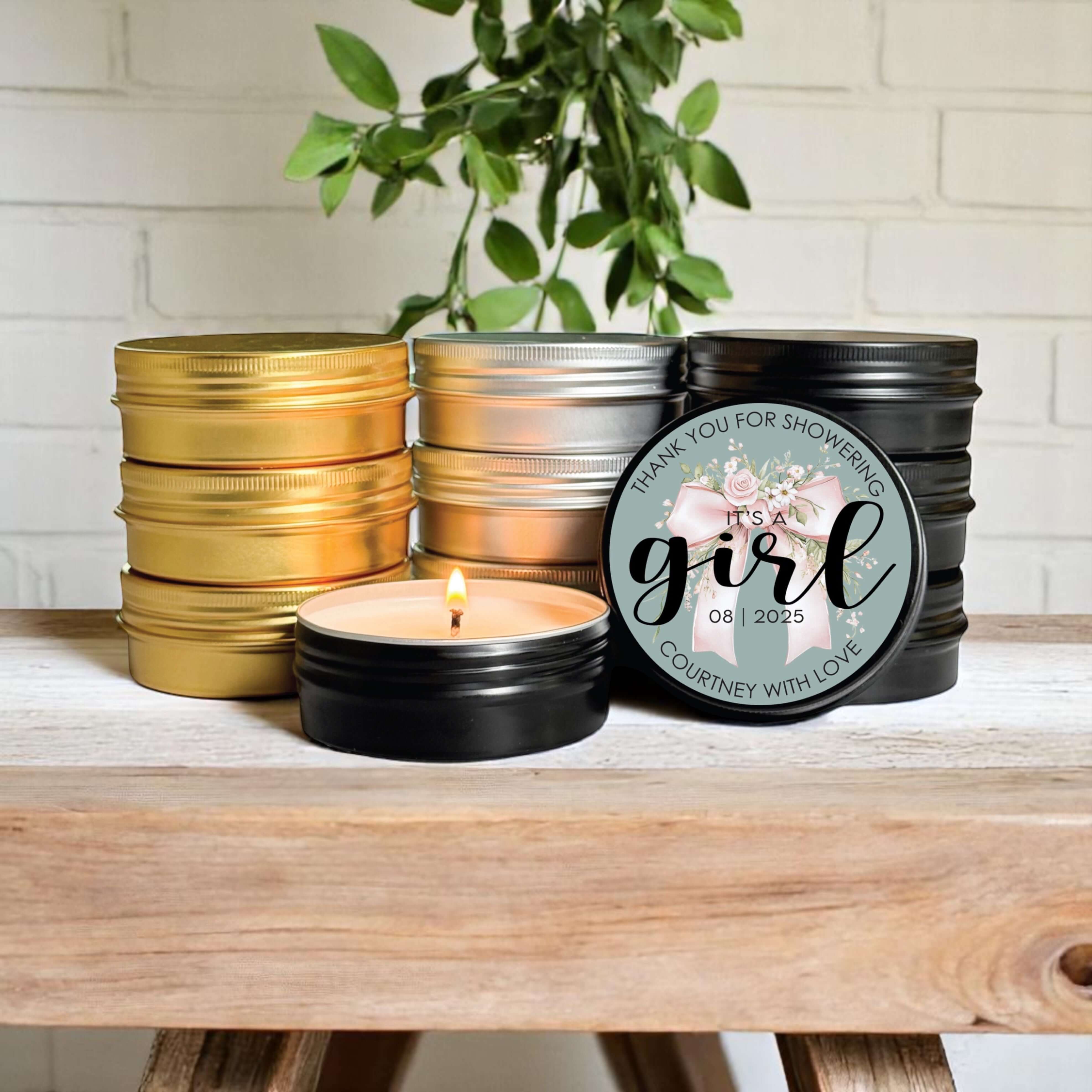 Bulk baby shower favors featuring stylish 2oz candle tins in gold, silver, and black with customizable labels.