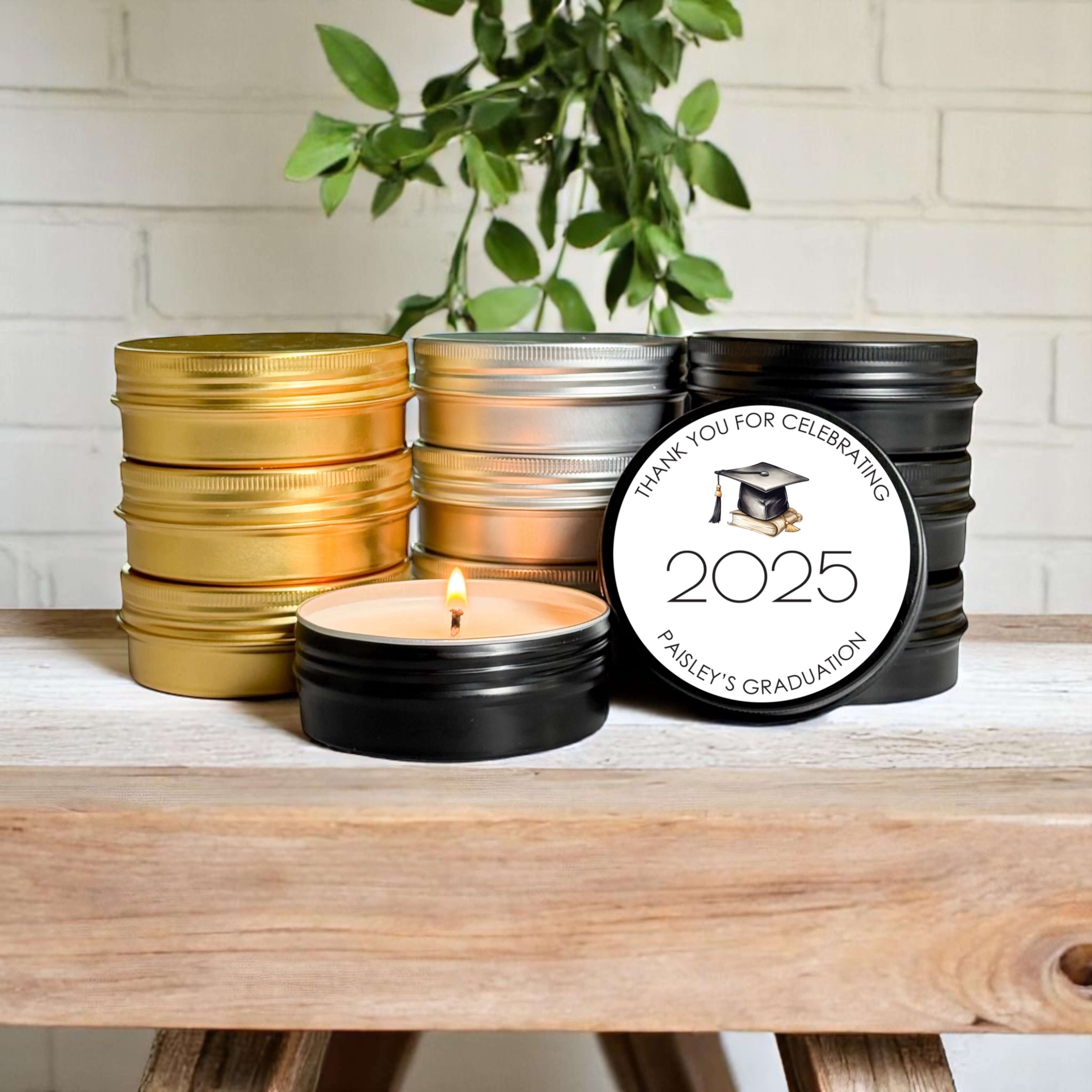 Bulk graduation favors featuring stylish 2oz candle tins in gold, silver, and black with customizable labels.