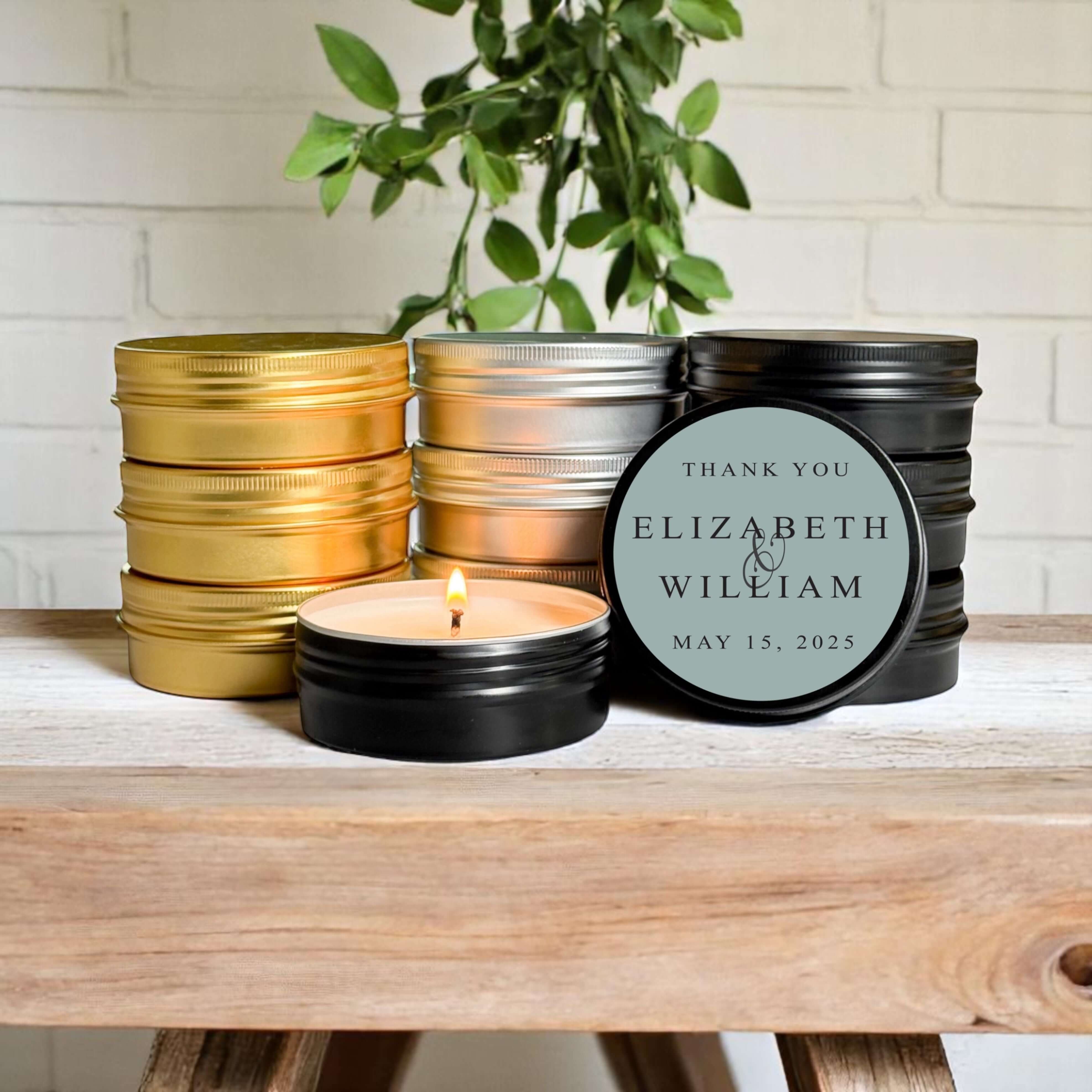 Bulk wedding favors featuring hand-poured soy candles in gold, silver, and black tins, personalized for events.