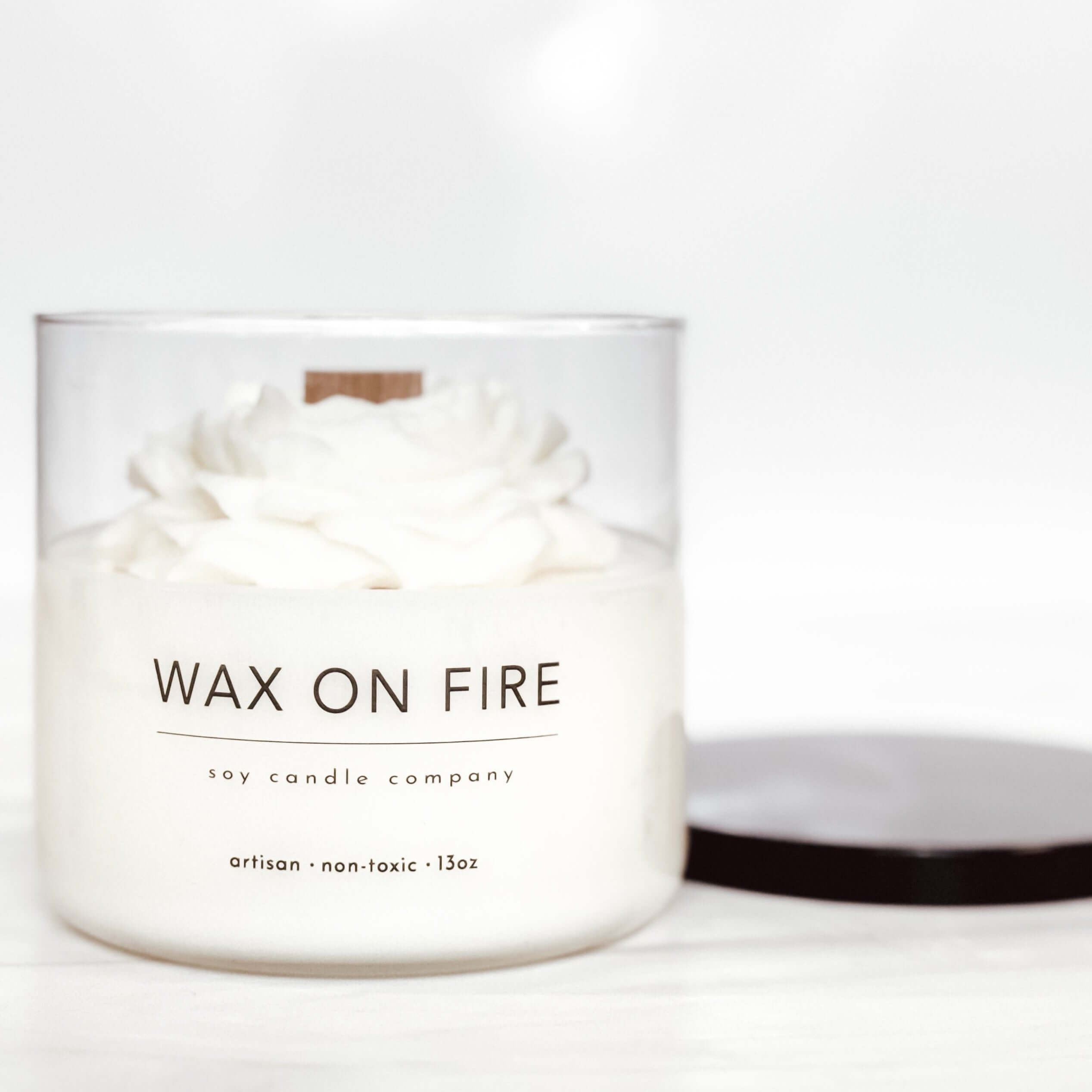 Peony flower candle in glass vessel by Wax On Fire, featuring non-toxic wax and a clean-burning wood wick.