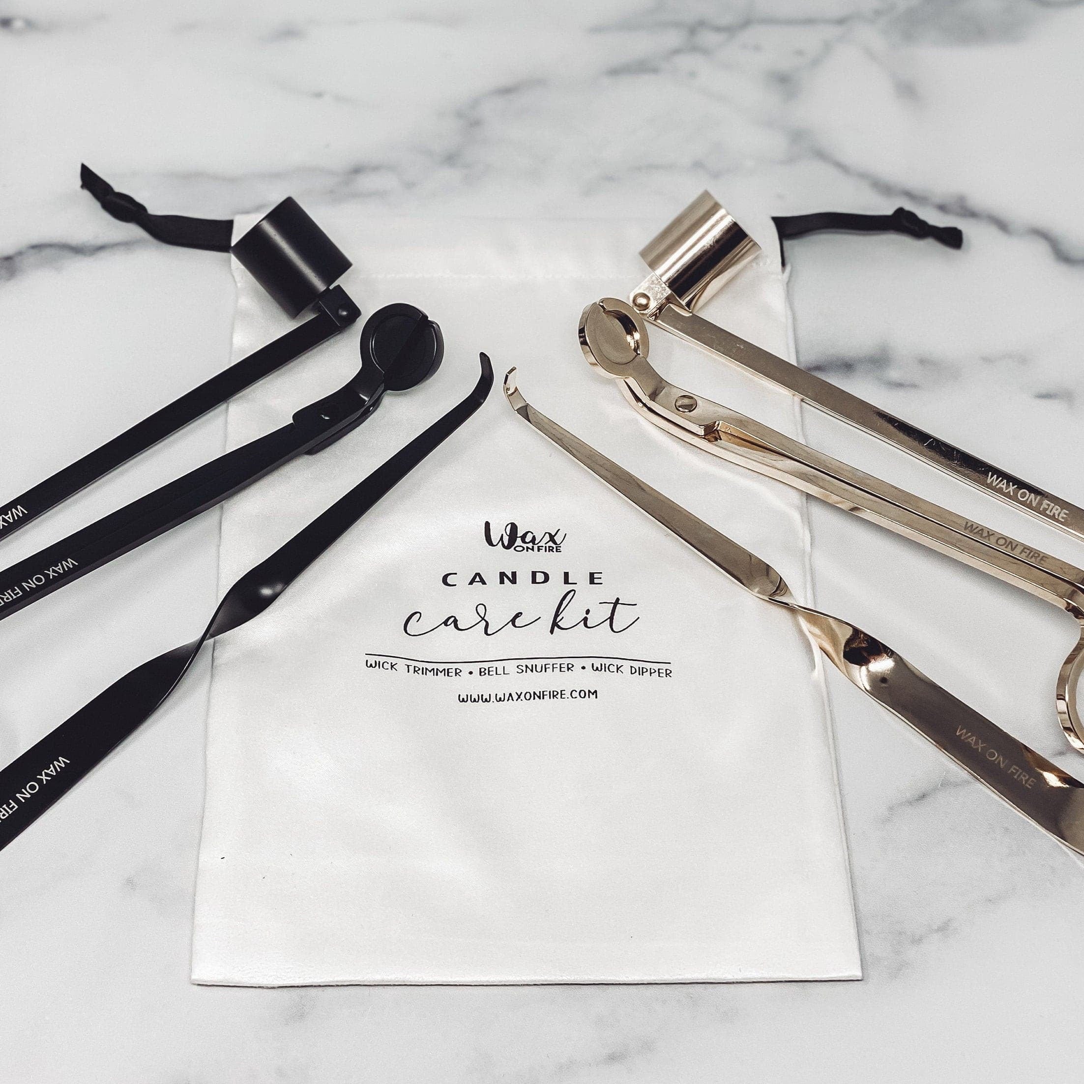 Candle Care Kit with bell snuffer, wick dipper, and wick trimmer in matte black and gold, presented in a pouch.